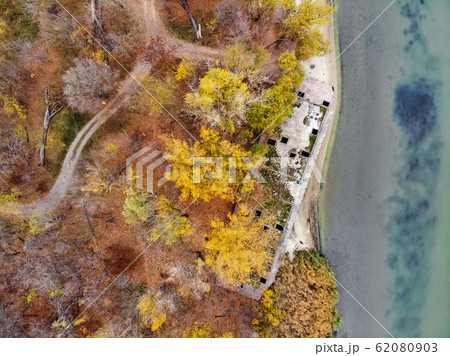 Top view old abandoned concrete ship on autumn river bank Top view old abandoned concrete ship on autumn river bank 62080903
