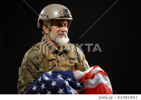 Military veteran holding american flag. Military veteran holding american flag. 62082891