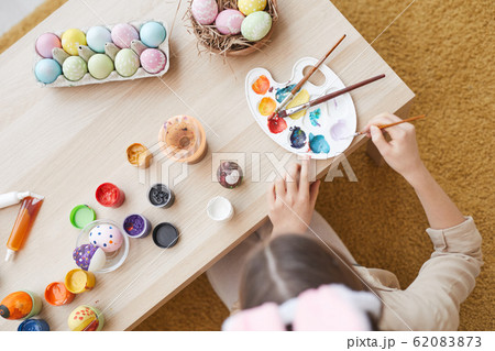 Girl painting Easter eggs Girl painting Easter eggs 62083873
