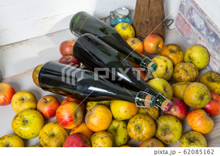 bottles of cider and apples of normandy 62085162