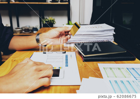 Businessman holding credit card and using smartphone. Businessman holding credit card and using smartphone. 62086675