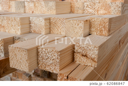 Close-up of unevenly protruding sawn rectangular wooden pine blocks . At the ends of visible tree fiber. Close-up of unevenly protruding sawn rectangular wooden pine blocks . At the ends of visible tree fiber. 62086847