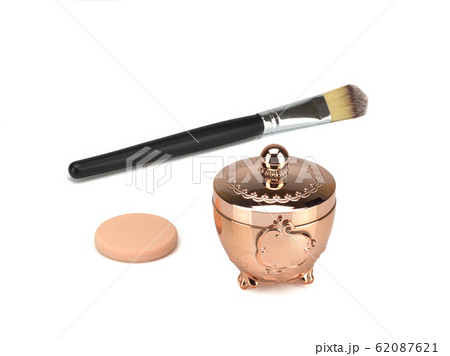 Golden jar with foundation for face, brush and sponge. Isolated on white background Golden jar with foundation for face, brush and sponge. Isolated on white background 62087621