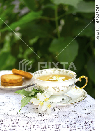 Jasmine herbal tea in a porcelain Cup with biscuit 62088767