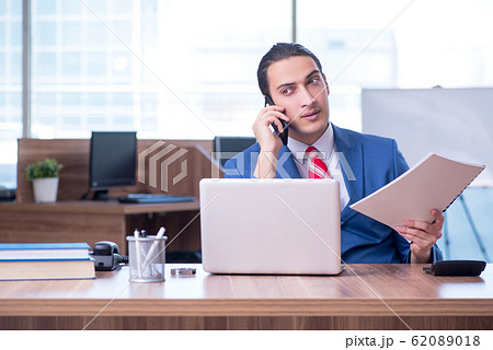 Young handsome businessman sitting in the office 62089018