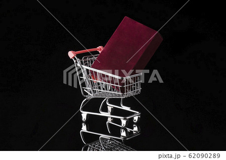 Shopping trolley cart and fragrance box on black 62090289