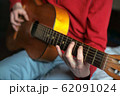 virtuoso guitarist playing his acoustic guitar 62091024
