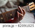virtuoso guitarist playing his acoustic guitar 62091025