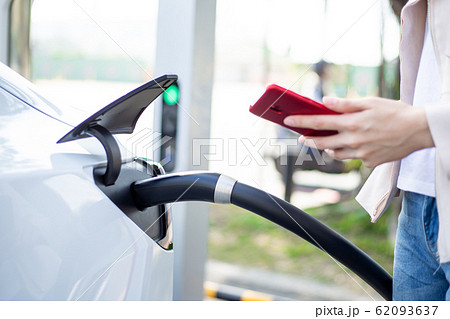 Woman charging electric car Woman charging electric car 62093637