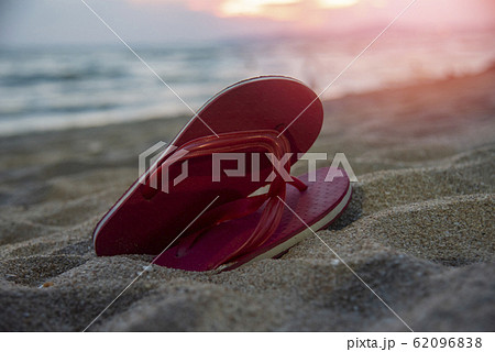 flip flops on beach with sandy beach sunset and 62096838