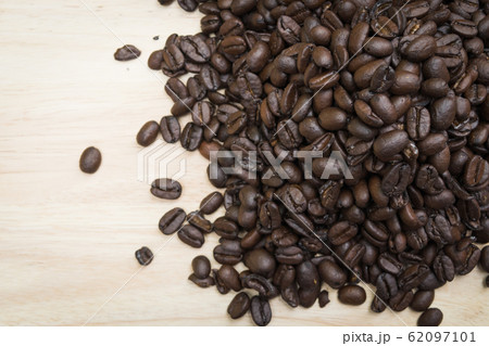 pile of coffee beans on wooden background 62097101