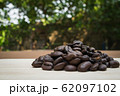 pile of coffee beans on wooden background 62097102