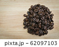 pile of coffee beans on wooden background 62097103