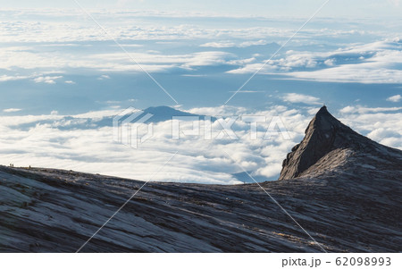 South Peak over clouds in the morning on Kota Kinabalu mountain in Malaysia South Peak over clouds in the morning on Kota Kinabalu mountain in Malaysia 62098993