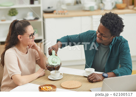 Couple drinking coffee at home Couple drinking coffee at home 62100517