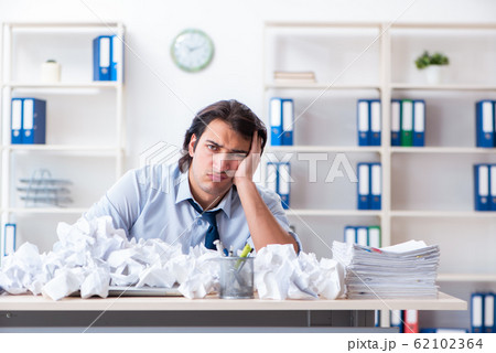Businessman rejecting new ideas with lots of papers 62102364