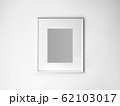 Blank white picture frame on white wall. 62103017