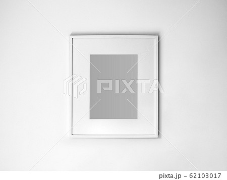 Blank white picture frame on white wall. 62103017
