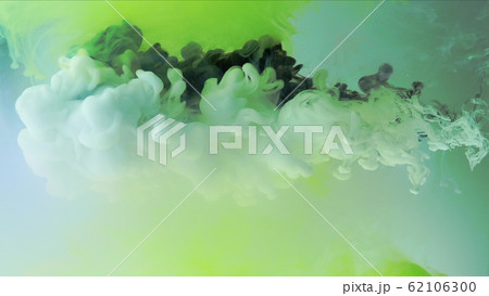 Multicolored composition from ink streams. Black and white streams of ink float and mix in the center of the composition. Colorful abstract combination of acrylic rainbow ink on a light green Multicolored composition from ink streams. Black and white streams of ink float and mix in the center of the composition. Colorful abstract combination of acrylic rainbow ink on a light green 62106300