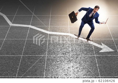 Businessman riding skateboard on financial graph Businessman riding skateboard on financial graph 62106426