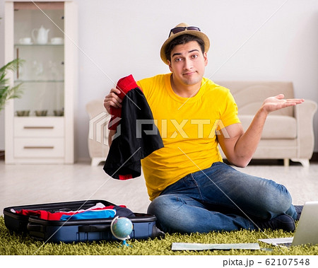 Man planning his vacation trip with map Man planning his vacation trip with map 62107548