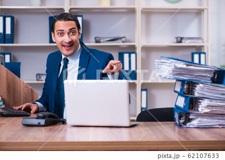 Young handsome businessman working in the office Young handsome businessman working in the office 62107633