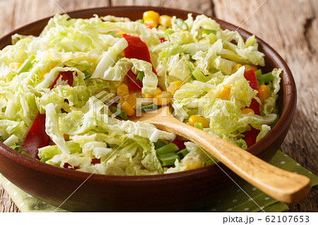 Rustic style savoy cabbage salad with corn, onions 62107653