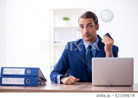Young male accountant working in the office Young male accountant working in the office 62108678