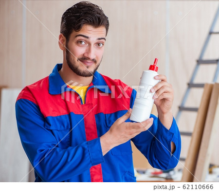 Yooung repairman carpenter working with paint painting Yooung repairman carpenter working with paint painting 62110666