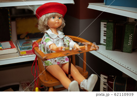 An old Soviet doll is sitting on a high chair 62110939