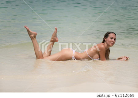 Young slim beautiful girl relaxes in the sea or Young slim beautiful girl relaxes in the sea or 62112069