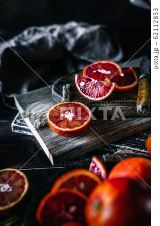 Whole and sliced sicilian blood oranges on a black old wooden background 62112853