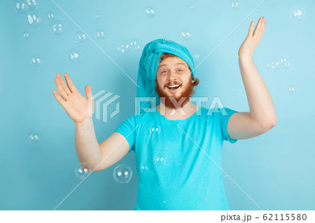 Portrait of young caucasian man in his beauty day and skin care routine Portrait of young caucasian man in his beauty day and skin care routine 62115580