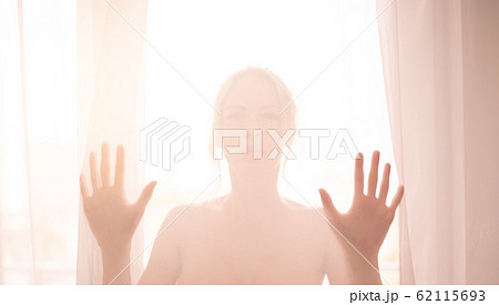 Defocus. High key light silhouette of a beautiful 62115693