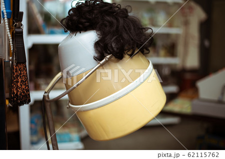 A wig is put on top of a hair dryer from the old A wig is put on top of a hair dryer from the old 62115762