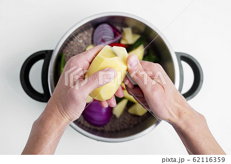 man preparing a vegetarian lentil stew. 62116359