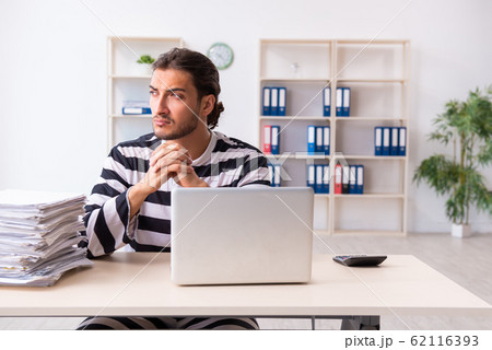 Young employee feeling like prisoner at work Young employee feeling like prisoner at work 62116393