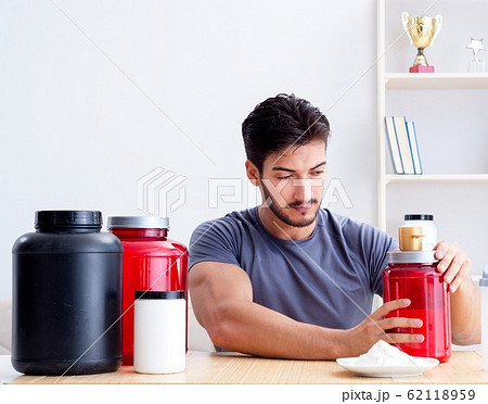 Athlete tasting new protein supplements for better muscles Athlete tasting new protein supplements for better muscles 62118959