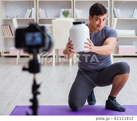 Sports and health blogger recording video in sport concept 62121812