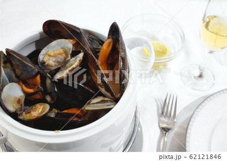 Pot of mussels and clams on a table isolated Pot of mussels and clams on a table isolated 62121846