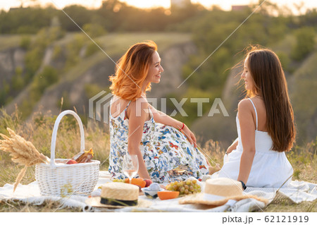 Two beautiful girlfriends spend time together on a 62121919