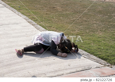 Little girl hiding her face. 62122726