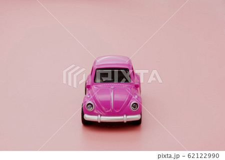 Miniature pink toy car on pink background. Minimal 62122990