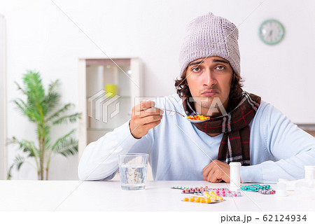 Young man suffering from flu at home 62124934