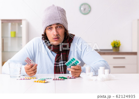 Young man suffering from flu at home Young man suffering from flu at home 62124935