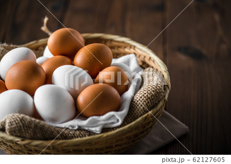Chicken eggs in basket on table. Chicken eggs in basket on table. 62127605