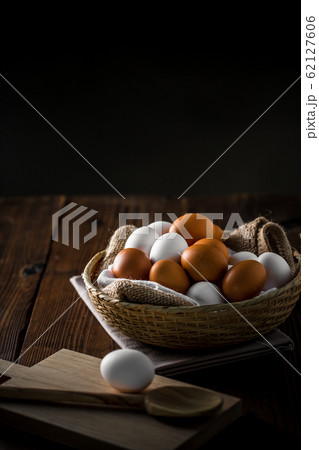 Chicken eggs in basket on table. Chicken eggs in basket on table. 62127606
