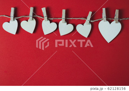 White wooden heart on a red background 62128156