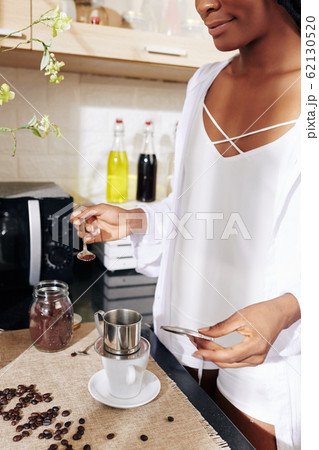 Woman making morning coffee 62130520