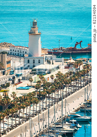 Malaga, Spain. Lighthouse and marina in sunny summer day 62134094